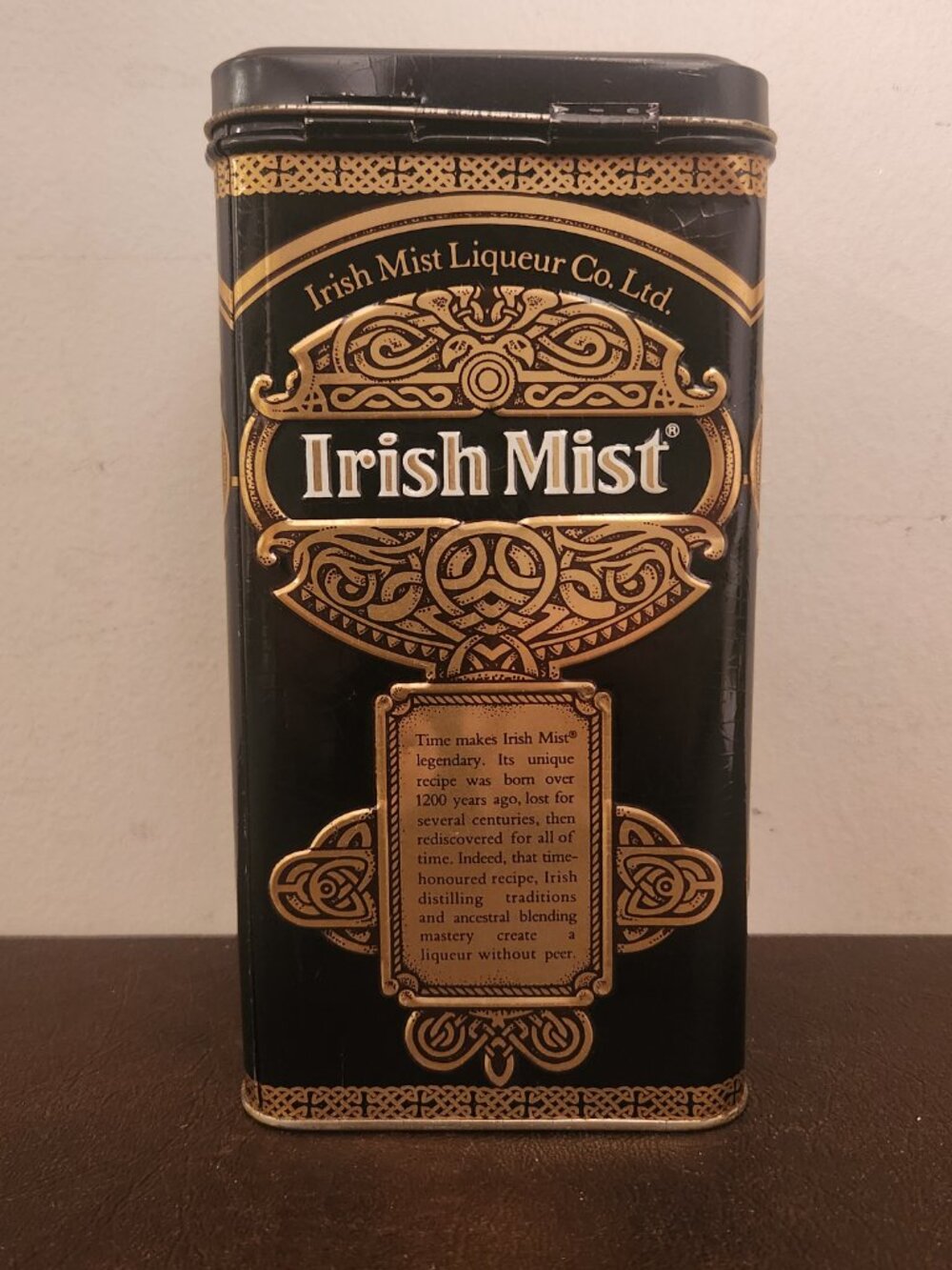 Vintage Irish Mist Liqueur tin features a classic black and gold design